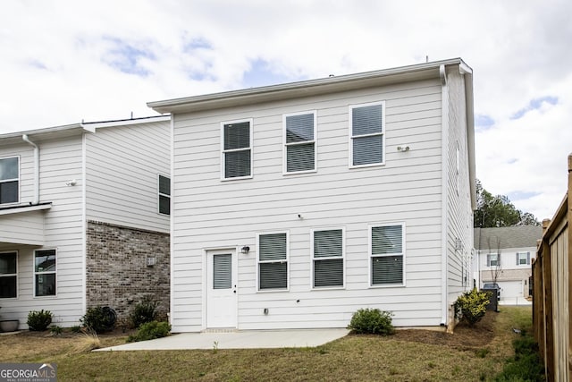 3739 Silvery Way, Powder Springs, GA 30127 - back of property featuring brick siding, a lawn, central AC, and a patio