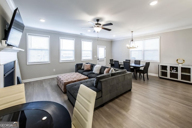 3739 Silvery Way, Powder Springs, GA 30127 - living area featuring crown molding, light wood-style flooring, ceiling fan with notable chandelier, and baseboards