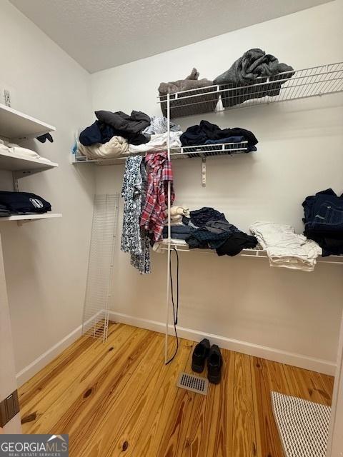 spacious closet with visible vents and light wood-type flooring