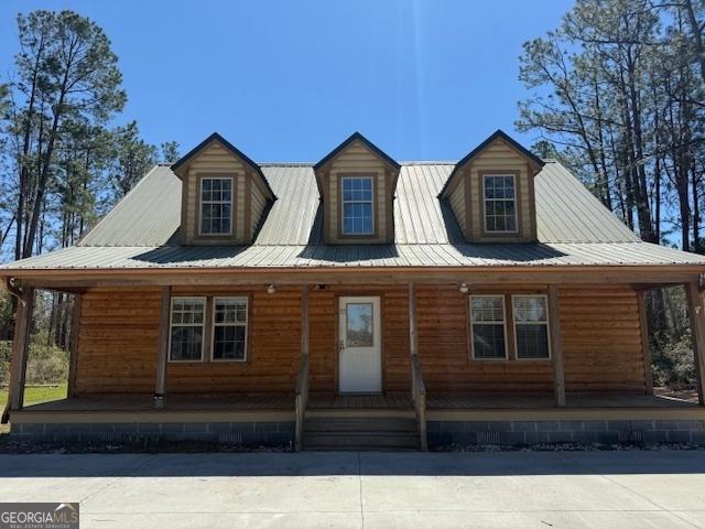 view of front of home with metal roof and a porch