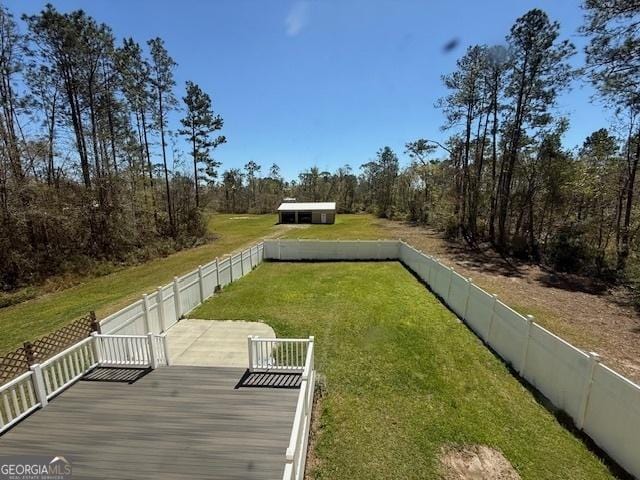 view of yard with a wooden deck and a fenced backyard