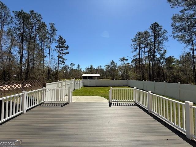 wooden deck featuring a fenced backyard