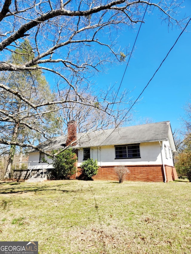 778 Mission Ridge Rd, Rossville, GA 30741 - view of front of property featuring a front lawn, a chimney, brick siding, and stucco siding