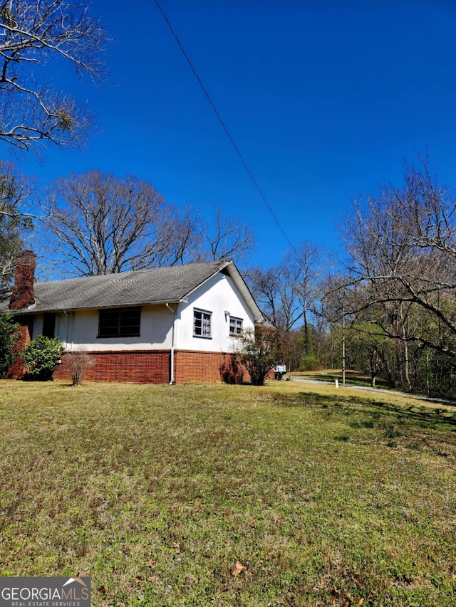 778 Mission Ridge Rd, Rossville, GA 30741 - view of property exterior featuring brick siding, a lawn, a chimney, and stucco siding