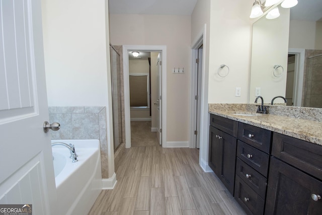39 Chatham Ct, Williamson, GA 30292 - full bath featuring a bath, wood finished floors, vanity, and a stall shower