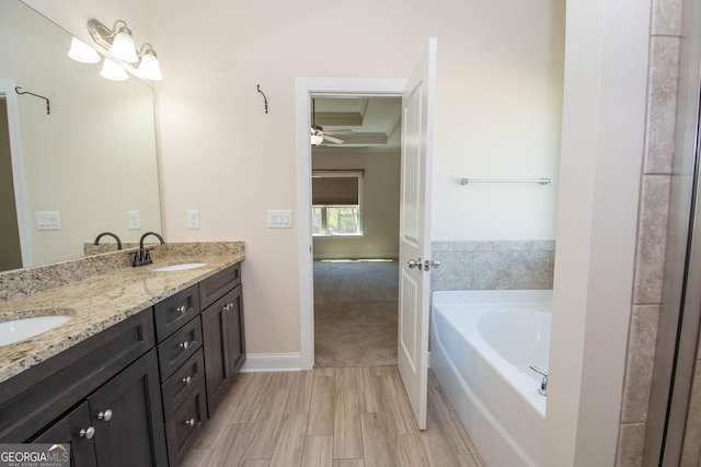 39 Chatham Ct, Williamson, GA 30292 - ensuite bathroom featuring double vanity, a bath, wood finished floors, and a sink