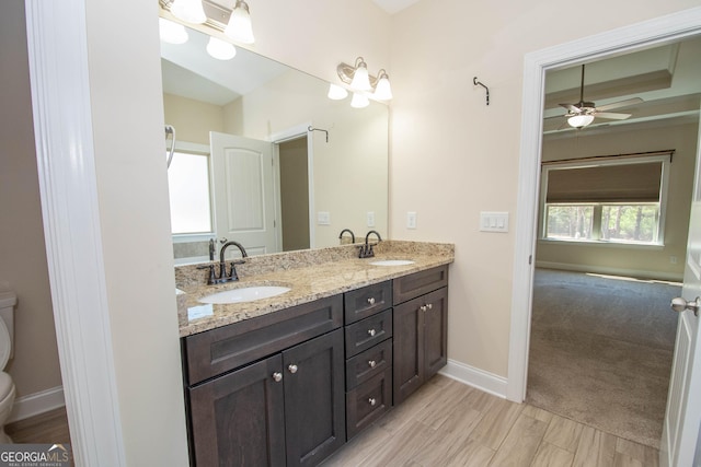 39 Chatham Ct, Williamson, GA 30292 - bathroom with double vanity, toilet, baseboards, and a sink