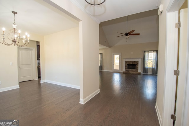 39 Chatham Ct, Williamson, GA 30292 - unfurnished living room featuring dark wood-style floors, baseboards, a fireplace with raised hearth, ceiling fan with notable chandelier, and lofted ceiling