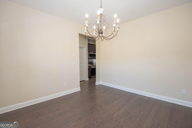 39 Chatham Ct, Williamson, GA 30292 - spare room with baseboards, a chandelier, and dark wood-style floors