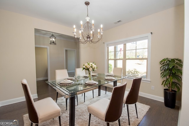 39 Chatham Ct, Williamson, GA 30292 - dining room with a chandelier, dark wood-type flooring, visible vents, and baseboards