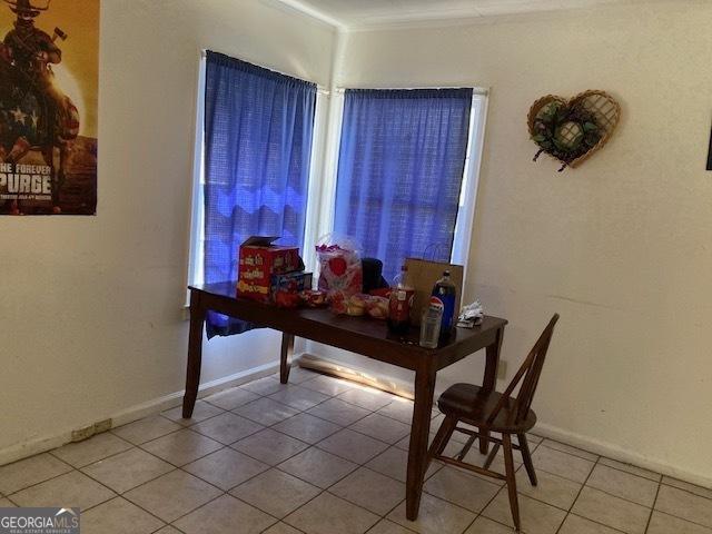 dining room featuring light tile patterned floors and baseboards