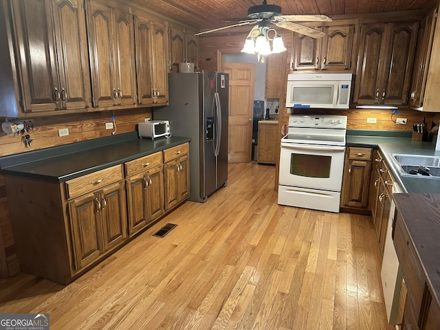 kitchen with visible vents, wood ceiling, light wood-type flooring, white appliances, and a ceiling fan