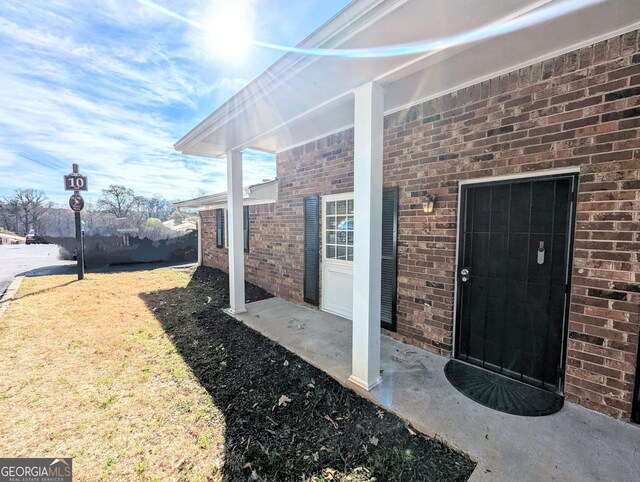 property entrance with brick siding