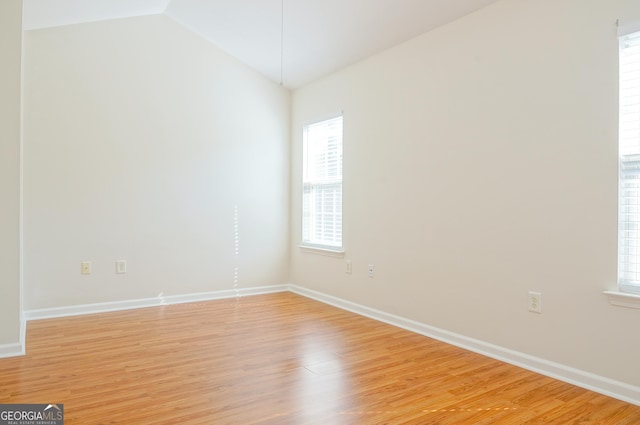 5352 Beaver Br, Norcross, GA 30071 - empty room with light wood finished floors, lofted ceiling, and baseboards