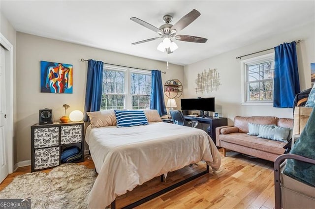 bedroom featuring light wood-style flooring and a ceiling fan