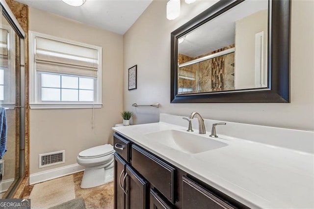 full bathroom with visible vents, a shower stall, baseboards, toilet, and vanity