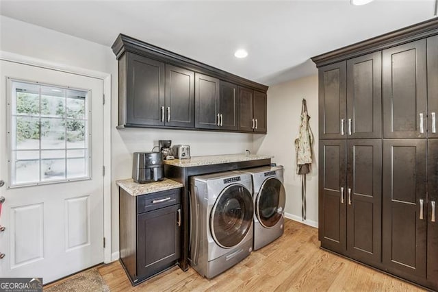 laundry room with baseboards, light wood finished floors, recessed lighting, cabinet space, and independent washer and dryer