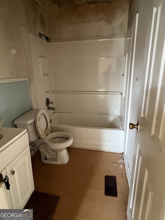 143 Oak St, Cochran, GA 31014 - bathroom featuring toilet, vanity, shower / bathtub combination, and wood finished floors