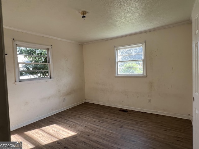 143 Oak St, Cochran, GA 31014 - spare room with ornamental molding, baseboards, a textured ceiling, visible vents, and wood finished floors