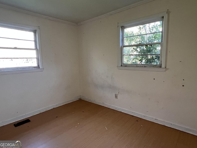 143 Oak St, Cochran, GA 31014 - spare room with baseboards, crown molding, and wood finished floors