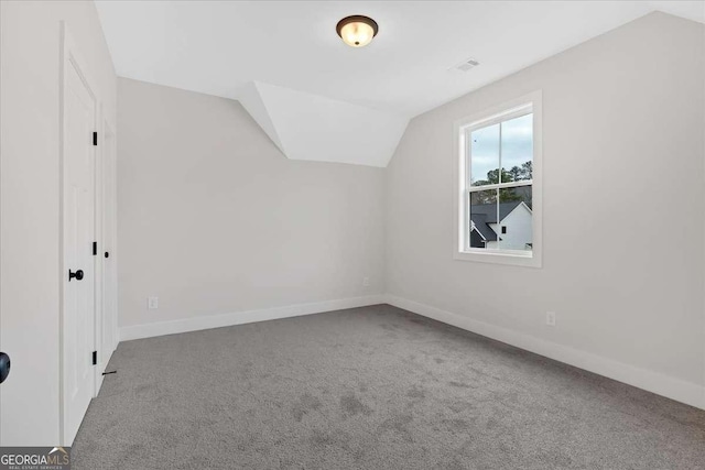 bonus room featuring vaulted ceiling, visible vents, baseboards, and carpet floors