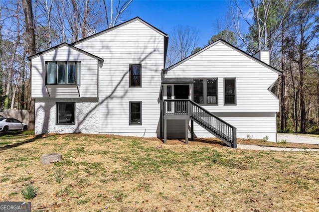 view of front of property featuring a chimney and a front yard
