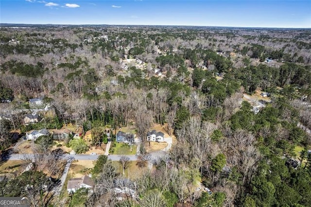 drone / aerial view featuring a wooded view