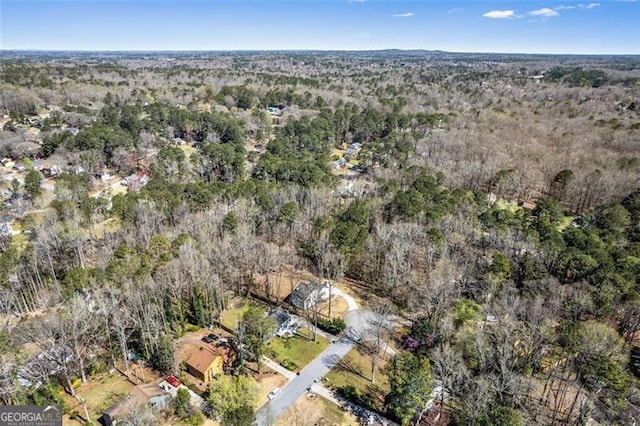 birds eye view of property featuring a view of trees
