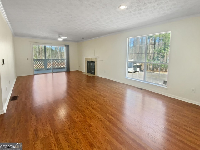 3705 Tradewinds Dr, Cumming, GA 30041 - unfurnished living room with wood finished floors, a fireplace, and visible vents