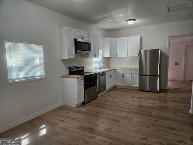 157 Knight St, Irwinton, GA 31042 - kitchen with white cabinetry, a sink, dark wood finished floors, and stainless steel appliances