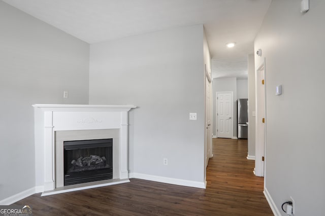 1579 Eastern Sunrise Ln, Decatur, GA 30034 - unfurnished living room with wood finished floors, baseboards, and a fireplace with raised hearth