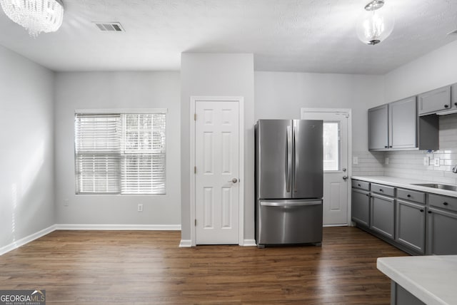 1579 Eastern Sunrise Ln, Decatur, GA 30034 - kitchen with decorative backsplash, dark wood finished floors, gray cabinets, and freestanding refrigerator