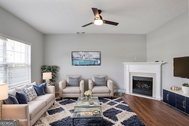 1579 Eastern Sunrise Ln, Decatur, GA 30034 - living room with dark wood-style floors, visible vents, a fireplace with raised hearth, and a ceiling fan