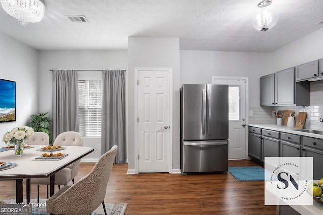 1579 Eastern Sunrise Ln, Decatur, GA 30034 - kitchen featuring gray cabinetry, backsplash, dark wood-style floors, freestanding refrigerator, and light countertops
