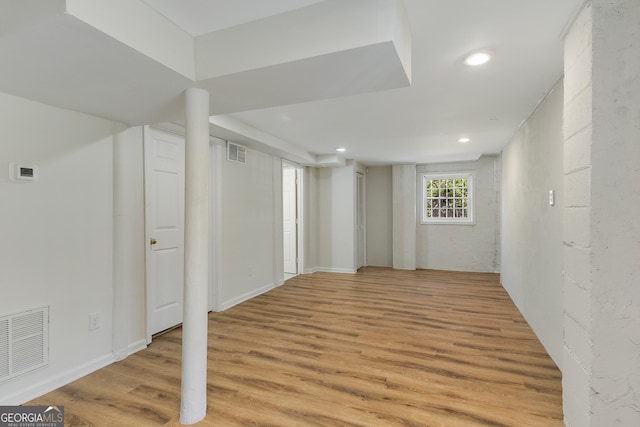 basement featuring recessed lighting, light wood finished floors, visible vents, and baseboards