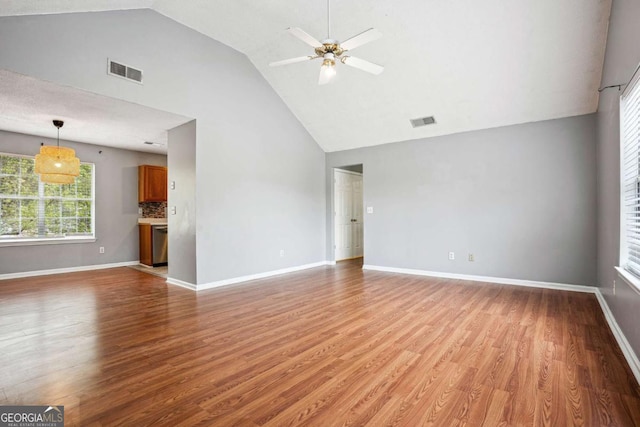 unfurnished living room with visible vents, light wood-style flooring, baseboards, and ceiling fan