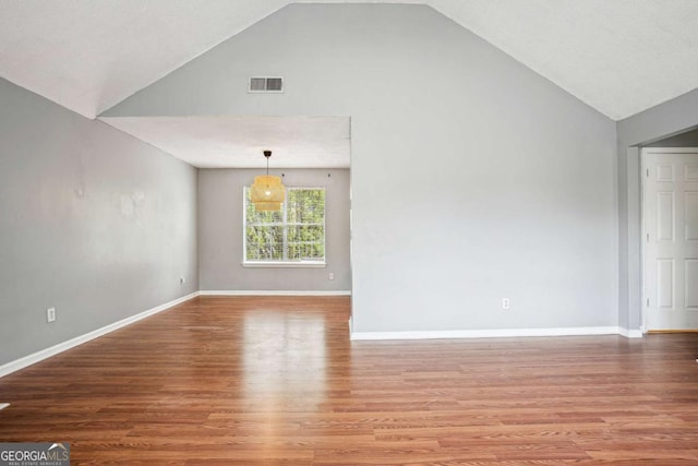 spare room featuring visible vents, baseboards, and wood finished floors