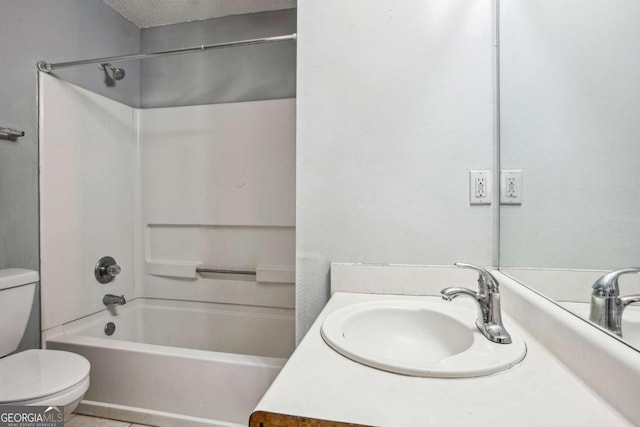 bathroom featuring vanity, toilet,  shower combination, and a textured ceiling