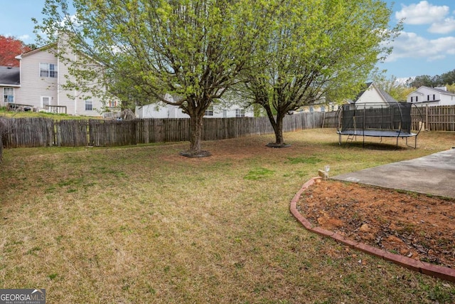 view of yard featuring a fenced backyard and a trampoline