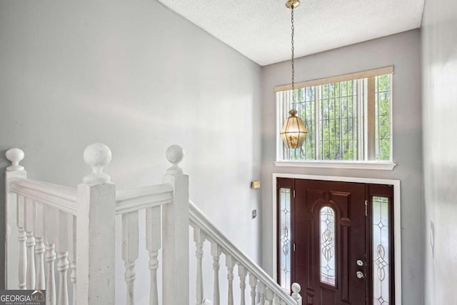 foyer entrance featuring a textured ceiling