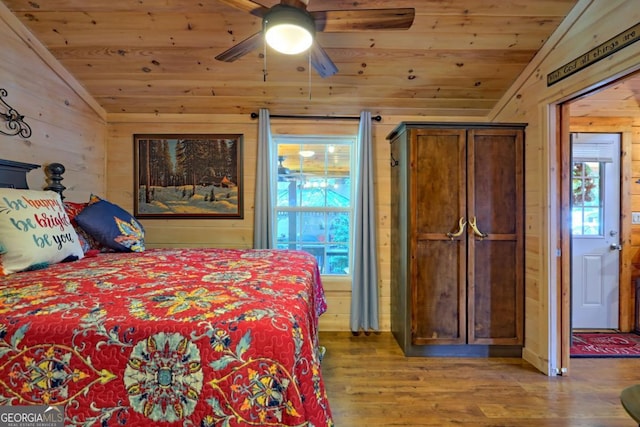 656 River Vista Dr, Dillard, GA 30537 - bedroom featuring lofted ceiling, wood ceiling, wood finished floors, wooden walls, and multiple windows