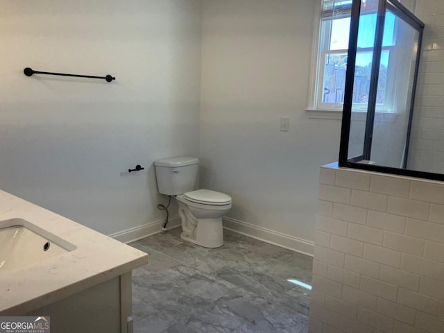 5099 Noble Village Way, Lilburn, GA 30047 - bathroom with toilet, vanity, and baseboards