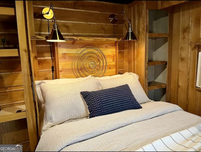 bedroom with wood walls