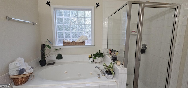 bathroom with a shower stall, a whirlpool tub, and a wealth of natural light