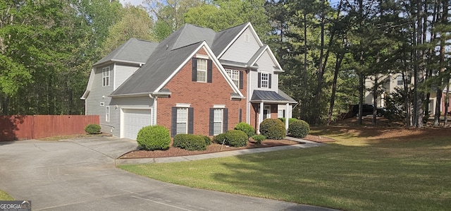 traditional-style home featuring roof with shingles, fence, a front lawn, brick siding, and driveway