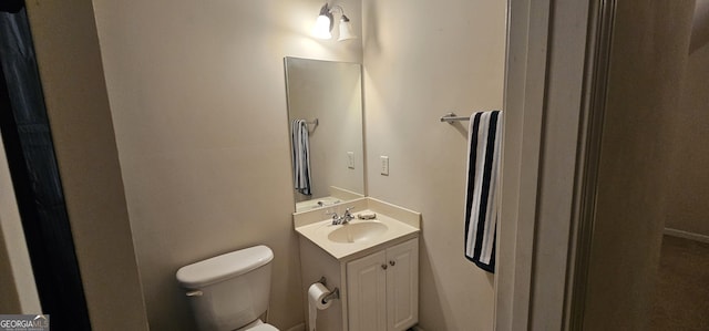 half bathroom with vanity and toilet