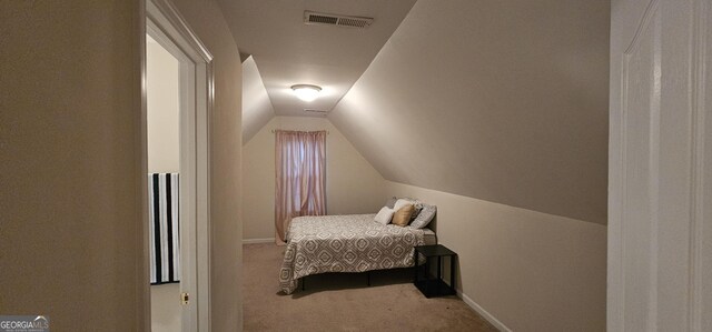 bedroom with visible vents, baseboards, vaulted ceiling, and carpet floors