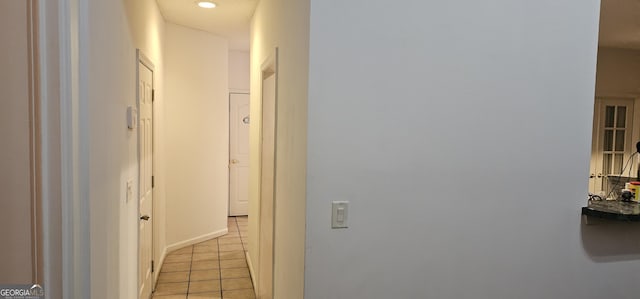 hall with light tile patterned flooring