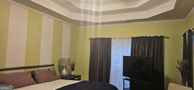 bedroom with visible vents and a tray ceiling