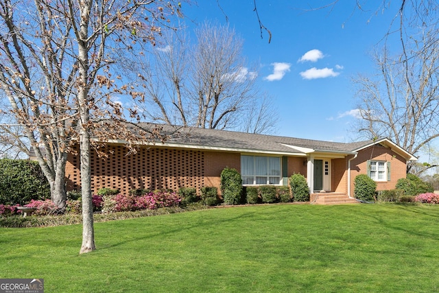 single story home featuring brick siding and a front yard